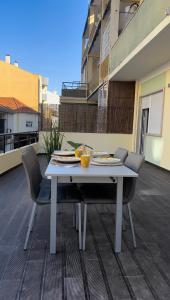 - Balcón con mesa blanca y sillas en Modern Spacious Apartment, en Entroncamento