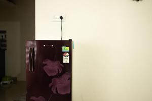 a refrigerator with purple hearts painted on it at Altrove AC Studio Apartment in Cochin