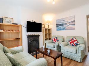 a living room with two couches and a tv at 160 Canterbury Road in Colchester