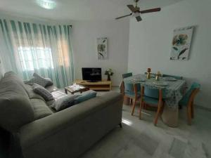 a living room with a couch and a table at Casita de la Infanta by Sanlúcar Housing in Sanlúcar de Barrameda