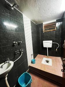 uma casa de banho com um lavatório e um WC. em HOTEL SWASTIK "free pick up from station & airport" em Deoghar