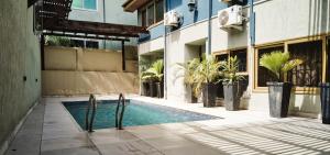 a swimming pool in the middle of a building at Sosa Guest House in Takoradi