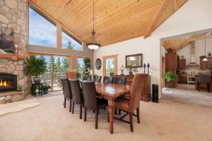 a dining room with a table and chairs and a fireplace at The Gemstone Grand by Leavetown Vacations in Grand Lake