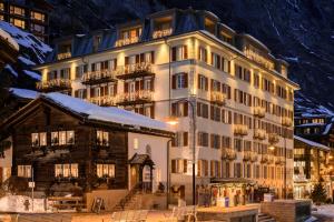 a large building in front of a building at Monte Rosa Boutique Hotel in Zermatt