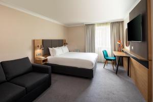 a hotel room with a bed and a couch at Holiday Inn Reading South M4 Jct 11, an IHG Hotel in Reading