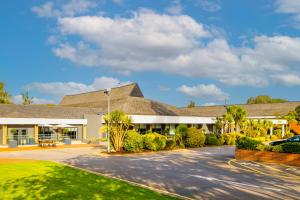 a building with a car parked in the driveway at Holiday Inn Reading South M4 Jct 11, an IHG Hotel in Reading