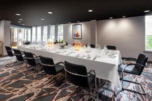 a large conference room with a long table and chairs at Holiday Inn Reading South M4 Jct 11, an IHG Hotel in Reading