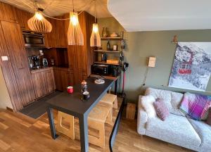 a living room with a table and a couch at Le Little Fox - IMMODREAMS - Avoriaz in Avoriaz