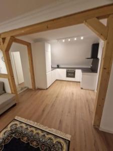 a large living room with wooden floors and a couch at Natur in Maintal