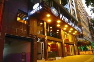 a store with a neon sign on the front of a building at ANKUVA HOTEL in Ankara