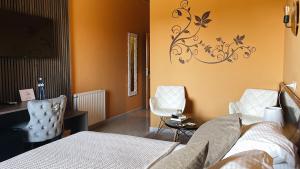 a bedroom with a bed and a desk and chairs at Hostal Rural Can Pau in Cantallops