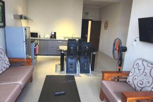 a living room with a couch and a kitchen at Number 8, 2nd Floor, Pebble Bay Apartments in Grand Baie