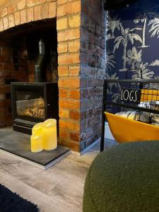 a brick fireplace with two candles in front of it at Canalside Terrace-Boutique Stay Worcester City in Worcester