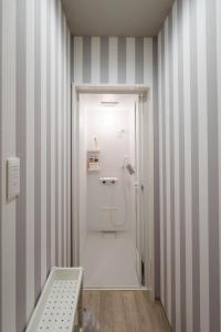a bathroom with a shower with striped walls at 深山邸miyama-tei in Zentsuji