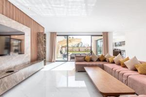 a living room with a couch and a fireplace at Luxury stylish 3suits villa in Marrakesh