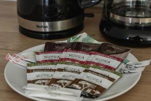 a plate with packets of teazos on top of a coffee maker at Apartment Five Seas with Parking & Swimming Pool by Renters in Sianozety