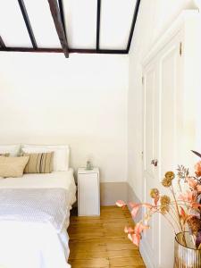 a bedroom with a bed and a wooden floor at Finca Origen · Casa Trinidad · Rural· Unique in San Pedro