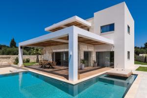 a villa with a swimming pool and a house at Sohora twin Villas in Xirostérnion