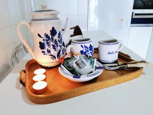 a tray with a tea pot and cups on a counter at CANTO DA AREA in Fisterra