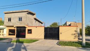 a building with a gate on the side of a street at Dtos El Descanso in Termas de Río Hondo