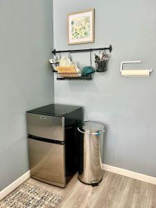 a small stainless steel refrigerator in a room at Cozy Country Get Away Studio at Firefly Acres in Olean