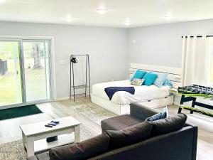 a living room with a couch and a bed at Cozy Country Get Away Studio at Firefly Acres in Olean