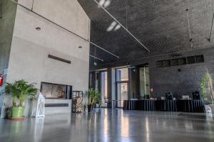 a large room with a lobby with plants in it at Hotel Skansen Conference&Spa in Sierpc