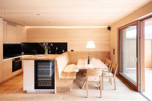 a kitchen and dining room with a table and chairs at Landhaus Damüls in Damuls