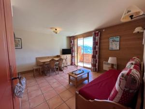 a living room with a couch and a table at Appartement Pra-Loup, 3 pièces, 8 personnes - FR-1-165A-45 in Uvernet