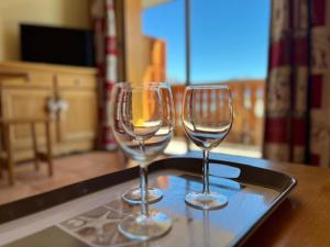 two wine glasses sitting on a tray on a table at Appartement montagne lumineux pour 8 pers, cuisine équipée - FR-1-165A-45 in Uvernet-Fours