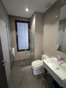 a bathroom with a toilet and a sink and a shower at 8 Kia Peng Suites KLCC by Luna in Kuala Lumpur