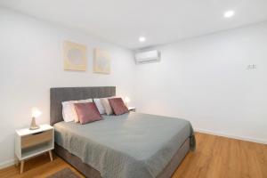 a bedroom with a bed and a nightstand with a bed sidx sidx sidx sidx at Telmus Villa Rc E in Monte Gordo