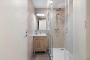 a bathroom with a shower and a sink and a mirror at Telmus Villa Rc E in Monte Gordo +15 photos