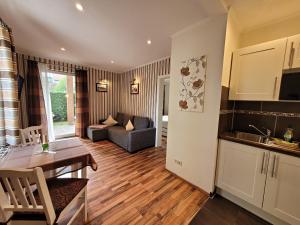 een keuken en woonkamer met een tafel en een bank bij Studio-Apartment Zacher 1 - 3 in Kühlungsborn +13 foto's
