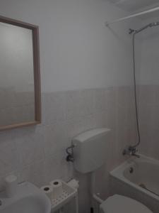 a bathroom with a toilet and a sink and a tub at Chiado / Carmo Small Artist Lodge in Lisbon