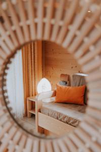 a view of a bedroom with a bed and a mirror at Chalet Les Hellebores in La Toussuire