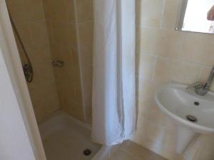 a bathroom with a shower curtain and a sink at Dream Away Luxor in Al Marīs +13 photos