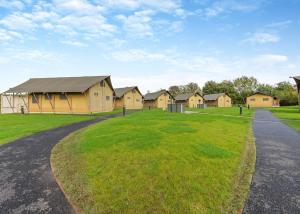 a row of houses in a field with a road at Ullswater Heights in Johnby