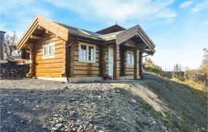 a small log cabin on a dirt road at Awesome Home In Reinli With Wifi And 1 Bedrooms in Reinli