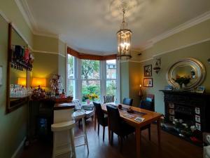 a dining room with a table and chairs at Arden House in Harrogate