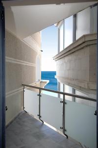 a hallway with a view of the ocean in a building at Plava Vila Beach Apartments Sveti Stefan in Sveti Stefan