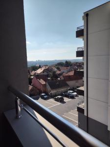 a balcony with a view of a parking lot at Apartman in Mali Mokri Lug