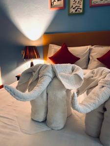 an elephant made out of towels on a bed at Lanta Grand House in Ko Lanta