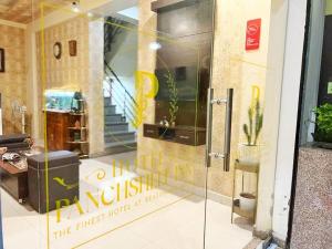 a glass door of a store with a sign on it at Hotel Panchsheel inn in Ajmer