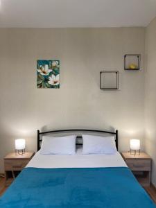a bedroom with a blue bed with two night stands at Власне Паркомісце! Апартаменти у новобудові, Городоцька street in Lviv