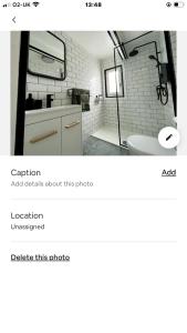 a bathroom with a sink and a mirror and a tub at Log Cabin in Bideford