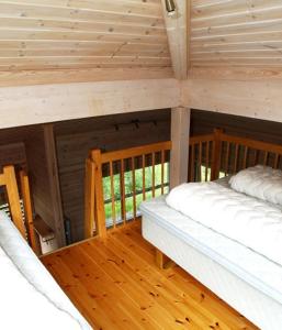 two beds in the attic of a log cabin at Risør Gjestehus in Risør