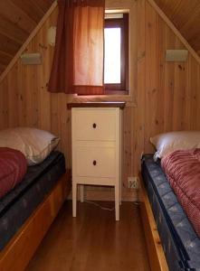 リソルにあるRisør Gjestehusの小さなベッドルーム(ベッド2台、窓付)