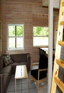 a living room with a couch and a table at Risør Gjestehus in Risør