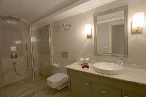 a bathroom with a sink, toilet and shower at Pinehill Hotel & Suites in Oludeniz